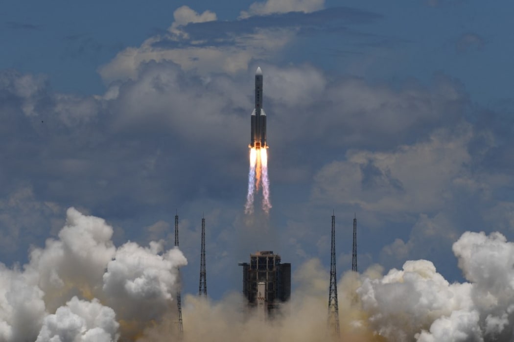 A Long March-5 rocket, carrying an orbiter, lander and rover as part of the Tianwen-1 mission to Mars, lifts off from the Wenchang Space Launch Centre in China's Hainan Province on July 23, 2020.