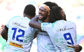 Selestino Ravutaumada of Fijian Drua (centre) celebrates scoring a try.
