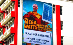 A strategically-placed billboard that was part of a lobbying campaign targeting energy minister Simon Watts, caputured by TVNZ's Q+A.