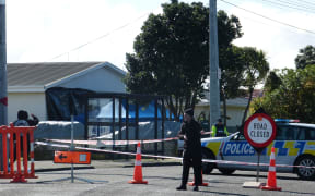 Police and members of the public at a cordon around the scene of the 21 August shooting.