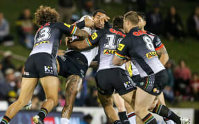 Warriors forward Adam Blair is hit in a big tackle against the Panthers.