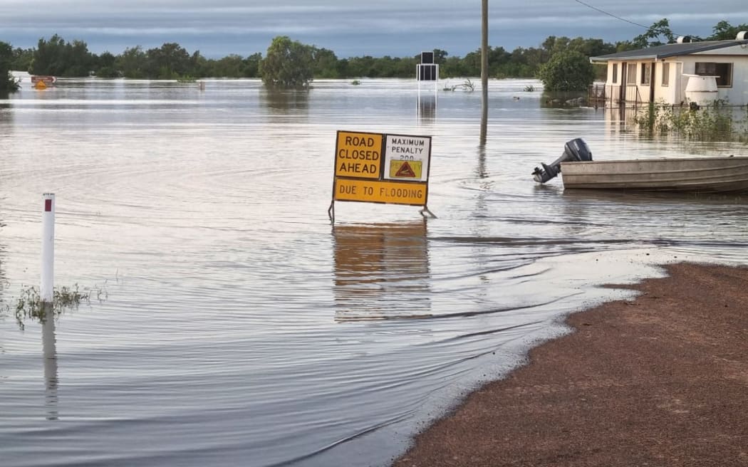 This handout photo taken on March 10, 2023 and received on March 11, 2023 from the Queensland Police Service shows a flooded street in the northern Queensland town of Burketown. - Police urged all residents of the remote Australian town to evacuate on March 11, 2023, warning that record-high floodwaters were expected to rise further over the weekend. (Photo by Handout / QUEENSLAND POLICE SERVICE / AFP) / ----EDITORS NOTE ----RESTRICTED TO EDITORIAL USE MANDATORY CREDIT " AFP PHOTO / QUEENSLAND POLICE SERVICE" NO MARKETING NO ADVERTISING CAMPAIGNS - DISTRIBUTED AS A SERVICE TO CLIENTS