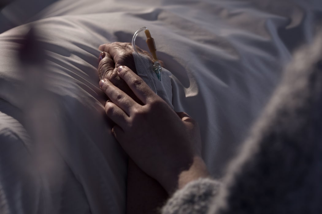 Photo of woman supporting dying mother with cancer