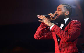 (FILES) In this file photo taken on February 07, 2019 Nipsey Hussle performs onstage at the Warner Music Pre-Grammy Party at the NoMad Hotel in Los Angeles. -