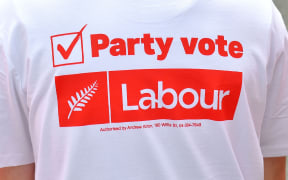 A young Labour supporter waits for the leader of the Labour Party Jacinda Ardern to arrive during a visit to a medical centre on the Labour Party's campaign trail in Wellington on September 19, 2017.