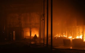 Firefighters work to put out flames at Barabashovo city market after a Russian aerial strike in Kharkiv, Ukraine, on 1 October, 2025.