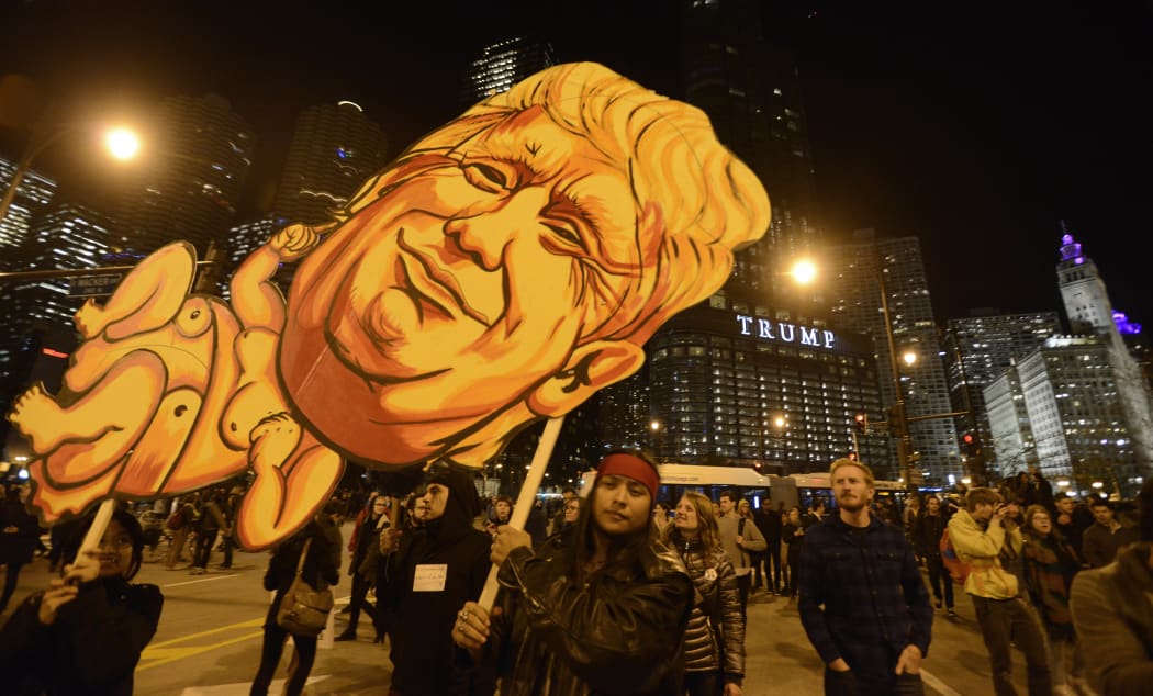 People take part in a protest near the Trump tower, against President-elect Donald Trump, in Chicago, Illinois on November 9, 2016.