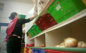 Volunteers sort food at the City Mission