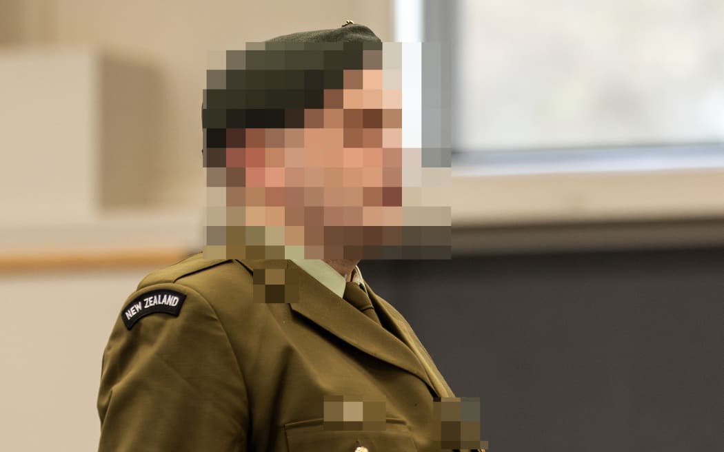 A New Zealand soldier stands at a makeshift courtroom at the Linton Military Camp located near the city of Palmerston North in New Zealand on August 18, 2025. A military court found a New Zealand soldier guilty of attempted espionage for a foreign power on August 18 -- the first spying conviction in the country's history. The man's name, the country he attempted to spy for and the name of the undercover officer who snared him were all suppressed by the court. The soldier was the first person to be convicted of spying by a New Zealand court and only the second to be tried after a former public servant was acquitted of espionage in 1975. (Photo by Adele Rycroft / POOL / AFP)