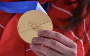 Switzerland's Mathilde Gremaud shows her gold medal, Winter Olympics, 2026.