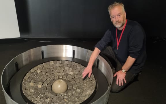 Bruce Aitken of the Len Lye Foundation looks at one of the sound cauldrons.