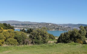 The view looking west at the rear access point to the prison: Evans Bay and Matairangi.