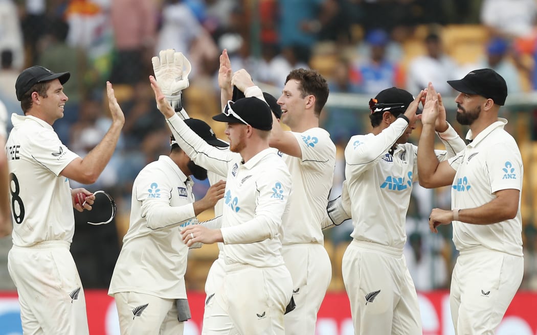 New Zealand players celebrates an Indian wicket during the first test in Bengaluru.