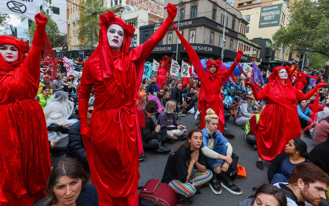 Demonstrators stage a sit-in on a road during a Extinction Rebellion protest in Melbourne on October 7, 2019.