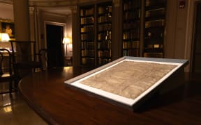 A rare copy of Magna Carta from 1300 sits in a display case at Harvard Law School in Cambridge, Massachusetts on 15 April 2025.