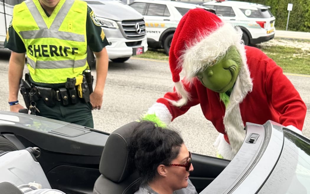 The grumpy ole' Grinch (who may double sometimes as Monroe County Sheriff's Office's Colonel Lou Caputo) was back out and about Friday, handing out onions and warnings to motorists and making friends at area schools.