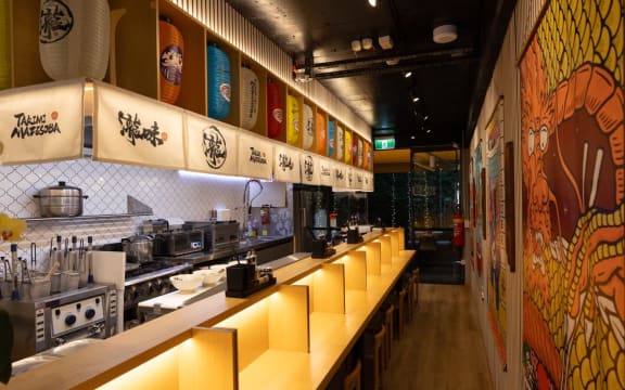 Dining booths for one welcome solo eaters at Takimi Mazesoba.
