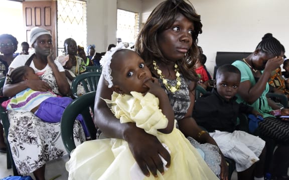 Women and children attending a mass in Monrovia for Ebola victims last month. Liberia's capital has been the hardest hit.