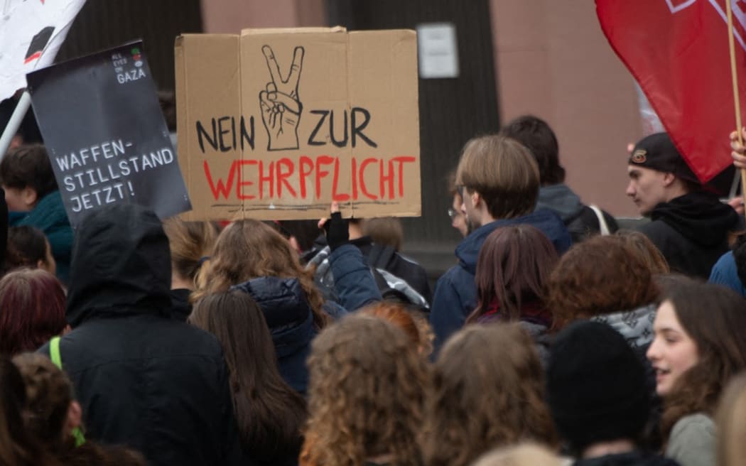 Hundreds of students gather in front of the Dom Cathedral and protest against voluntary conscription, demanding more money to invest in education in Cologne, Germany, on 5 December, 2025, as part of a nationwide student strike.