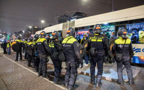 Dutch mobile Police officers stand guard after several scuffles broke out in the city center following the UEFA Europa League, League phase - Matchday 4, football match between Ajax Amsterdam and Maccabi Tel Aviv, in Amsterdam on November 8, 2024. - Dutch Prime Minister Dick Schoof described “anti-Semitic attacks on Israelis” in Amsterdam as “unacceptable”, in a message posted on his X account. (Photo by VLN Niews / ANP / AFP) / Netherlands OUT / NETHERLANDS OUT