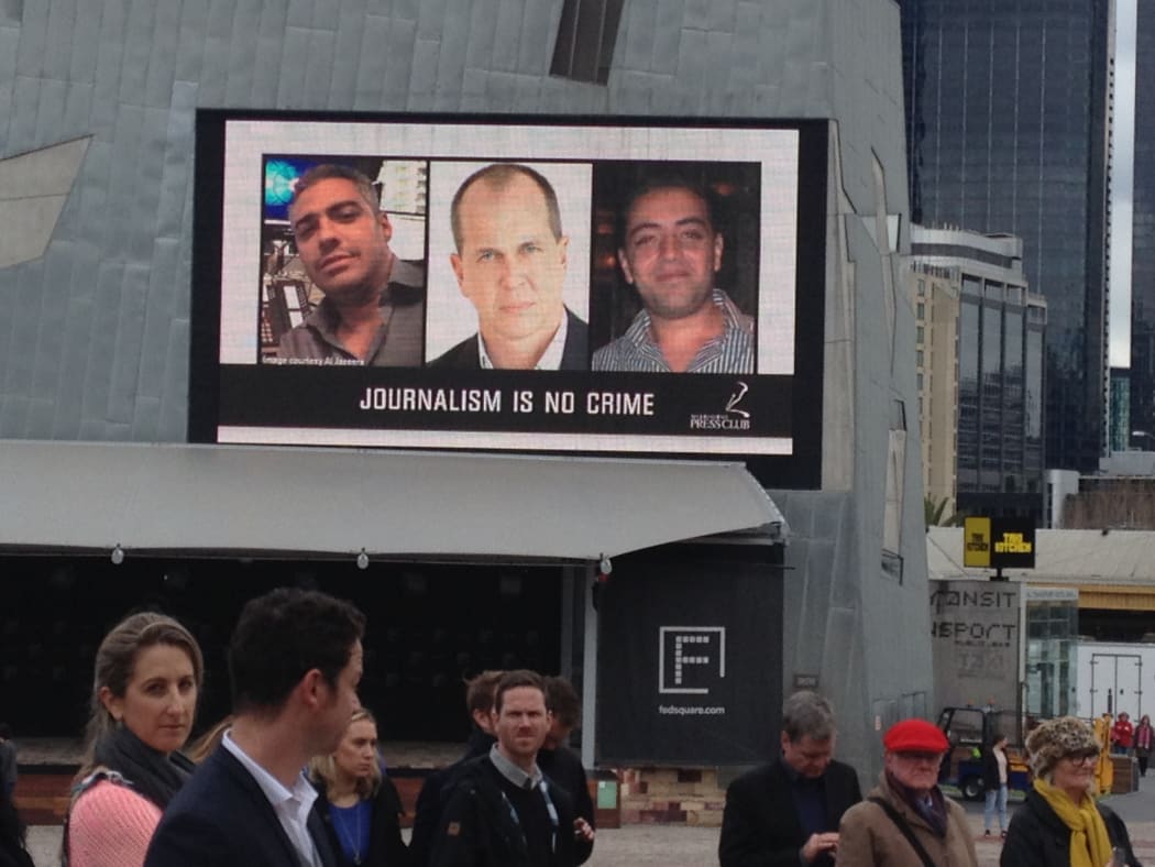 An image of journalists Mohamed Fahmy (left), Peter Greste and Baher Mohamed  on a big screen at a rally in Melbourne last year calling for their release.