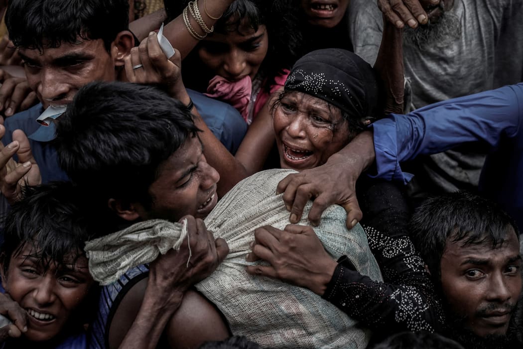 Rohingya refugees scramble for aid at a camp in Cox's Bazar, Bangladesh September 24, 2017.