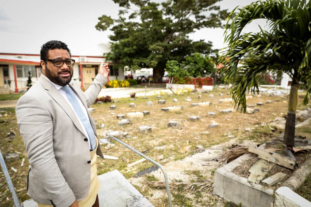 Tonga Parliament's Speaker Lord Fakafanua points out the courts buildings beyond the site where the Parliament building once was.