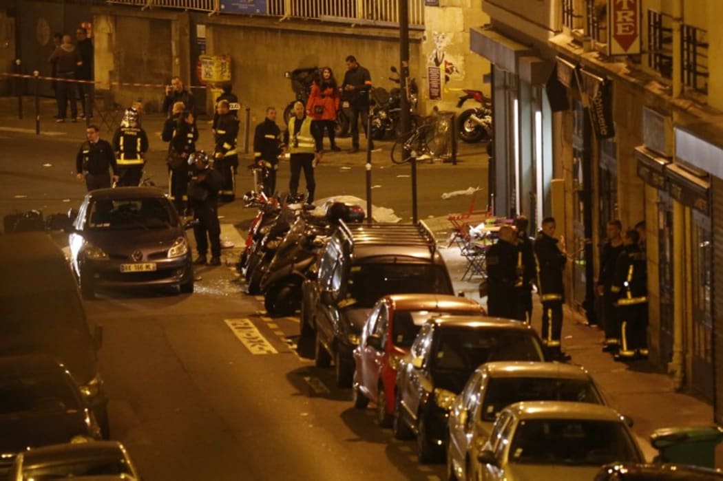 Rescuers and police cordon off the area close to Rue Bichat following several attacks in Paris
