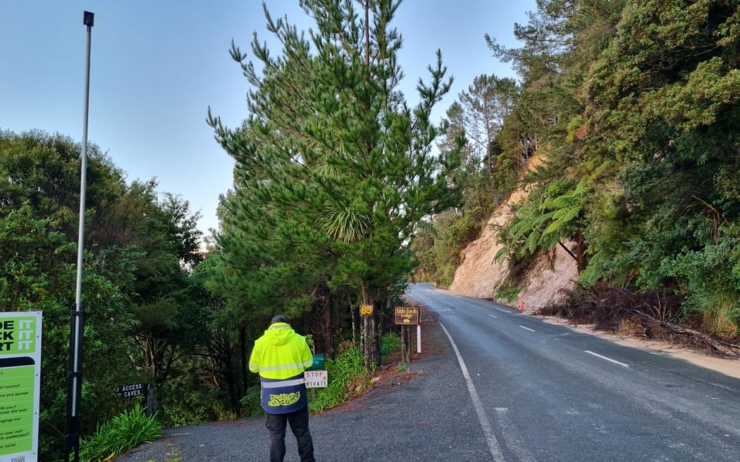 A security guard at the entrance to Abbey Caves, Northland, where a body was recovered during a search for a Year 11 student from Whangārei Boys' High School missing on a trip into the caves with a school party.