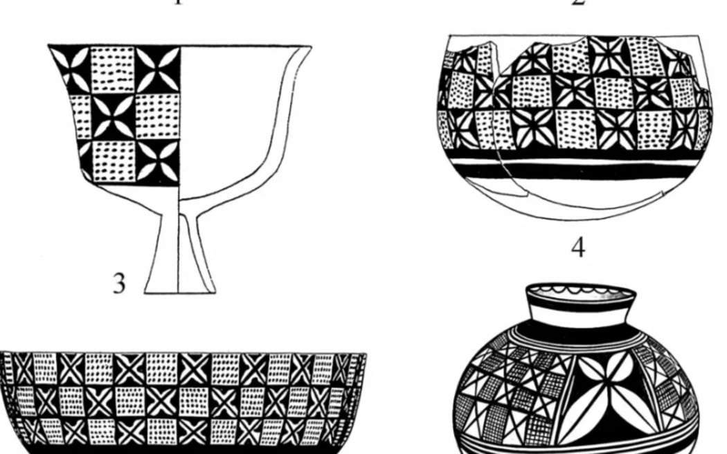 Small flowers with four petals sit inside the black squares of a checkerboard pattern.