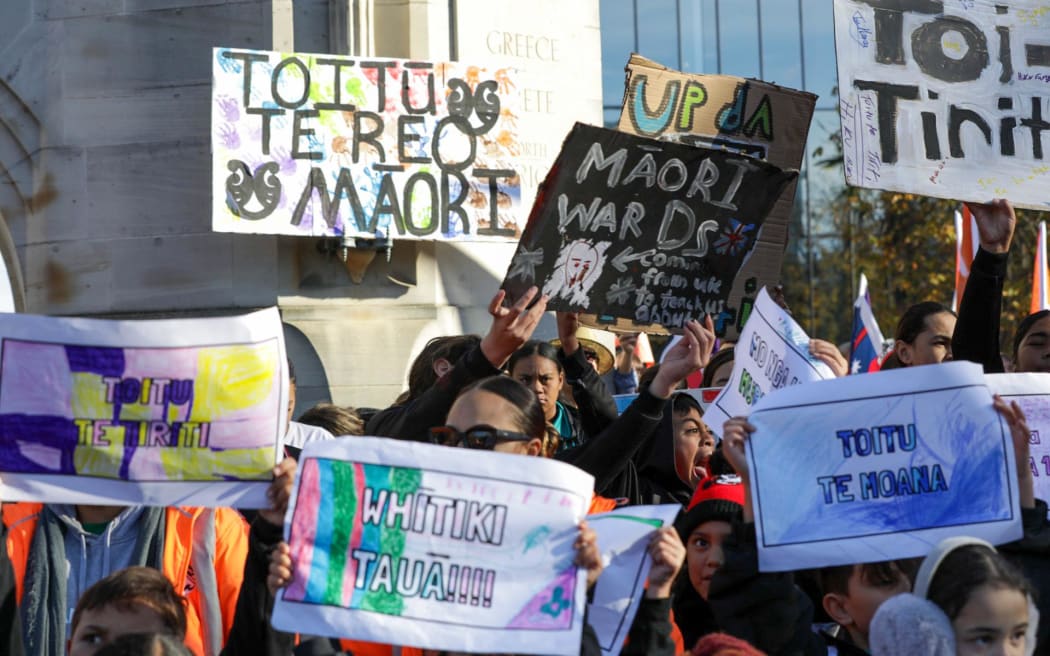 Protestors gather near the Bridge of Remembrance in Christchurch