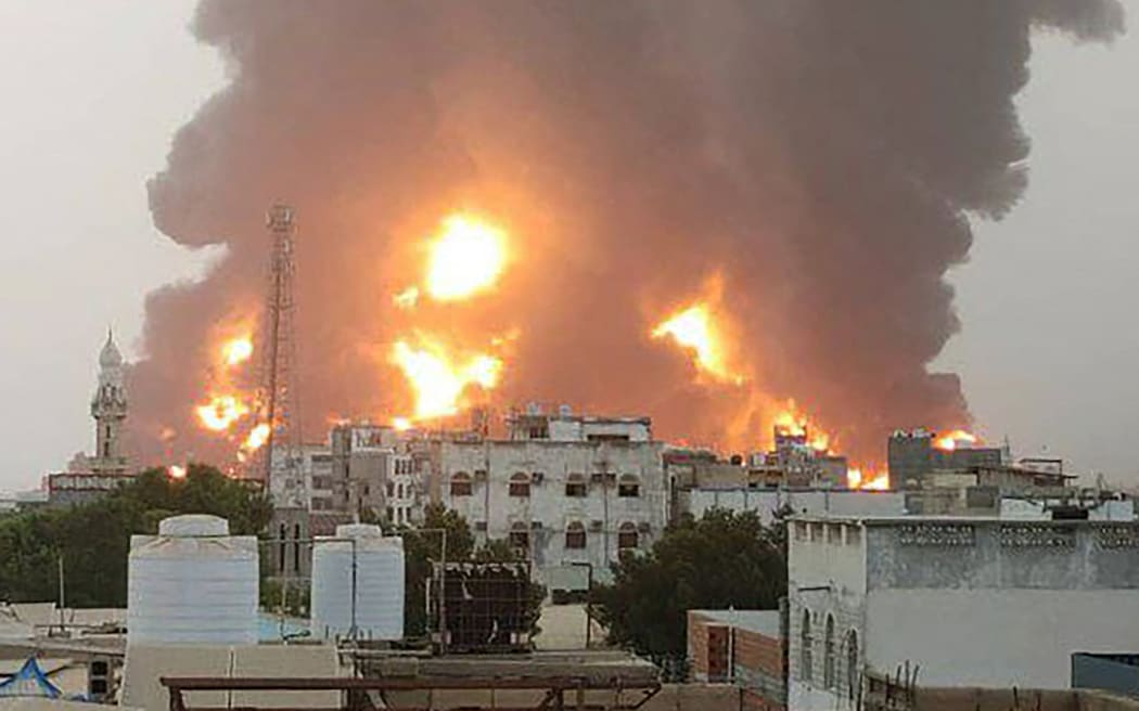 A handout picture obtained from Yemen's Huthi Ansarullah Media Center show a huge column of fire erupting following reported strikes in the Yemeni rebel-held port city of Hodeida opn July 20, 2024. A series of strikes targeted Hodeida on July 20, said an AFP correspondent and Huthi-run media, which reported a fuel depot in the port had been hit.