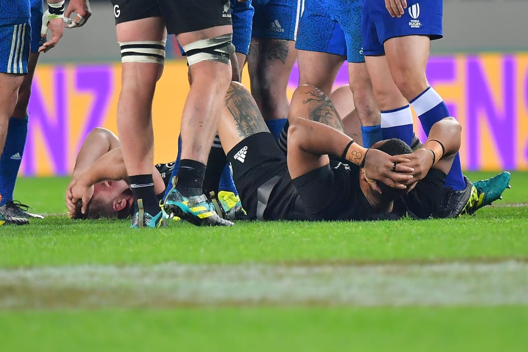 France's Remy Grosso (L) lays on the ground after running into All Blacks Ofa Tu'ungafasi (R  during the Steinlager Series rugby match between the All Blacks and France at the Eden Park in Auckland on Saturday the 9th of June 2018. Copyright Photo by Marty Melville / www.Photosport.nz