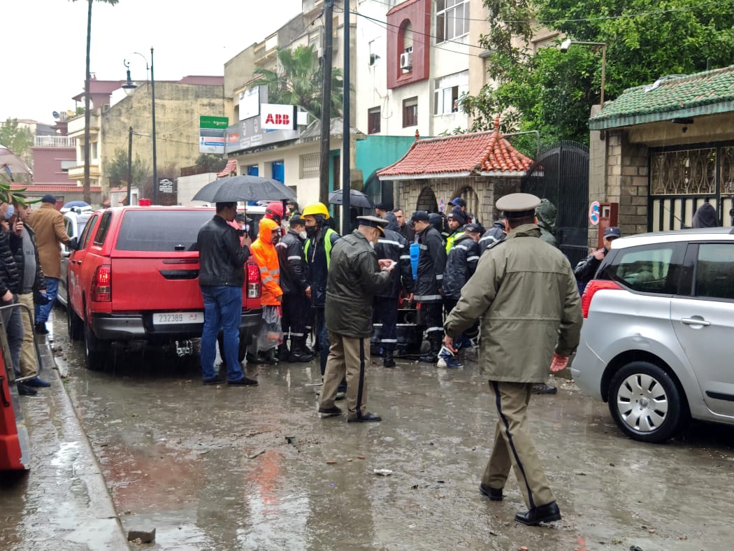 Emergency services gather at the site of illegal underground textile workshop that flooded after heavy rain fall in Morocco's city of Tangiers.