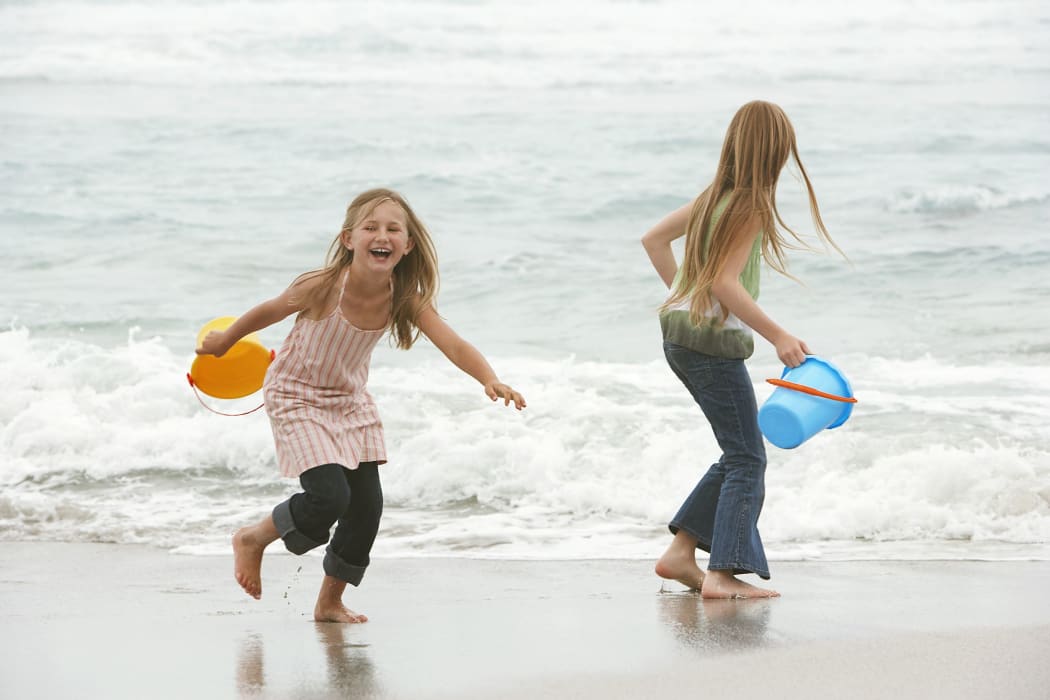 19521586 - two girls playing at the ocean