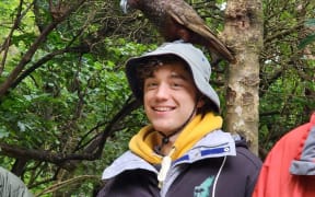 Max Barrett with a kākā on Kapiti Island