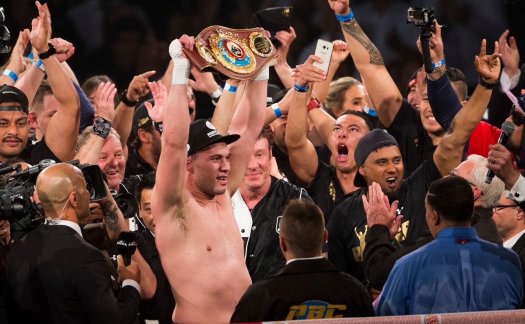 New Zealand heavyweight Joseph Parker holds up the WBO belt alongside his team.