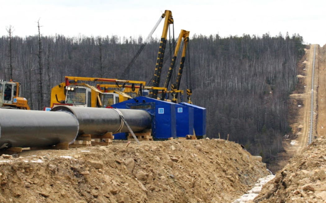 Picture taken 13 October 2006 shows pipes and equipment near a trench of the oil pipeline Eastern Siberia - the Pacific Ocean in Siberian Tynda-Skovorodino region, 13 October 2006. AFP PHOTO (Photo by AFP)