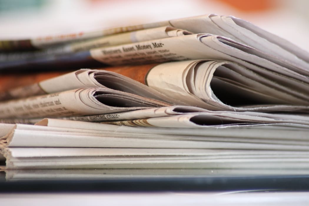 A stack of folded newspapers (file)