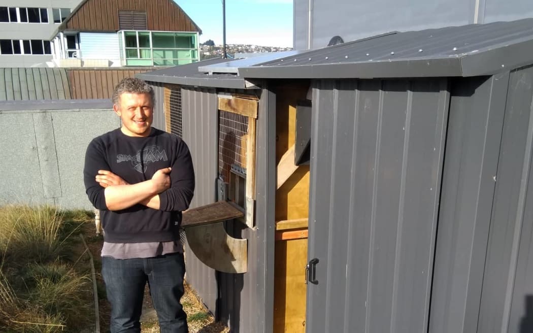 Dr. Damien Scarf, psychology lecturer at Otago University outside his pigeon loft.