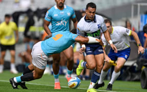 Moana Pasifika halfback Augustine Pulu tackles Blues opposite Sam Nock.