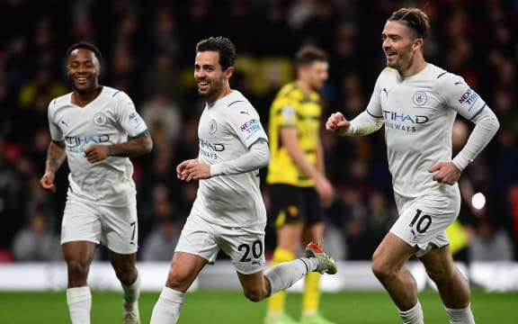 Manchester City's Portuguese midfielder Bernardo Silva (2L) celebrates scoring his team's third goal during the English Premier League football match against Watford at Vicarage Road Stadium in Watford on December 4, 2021.