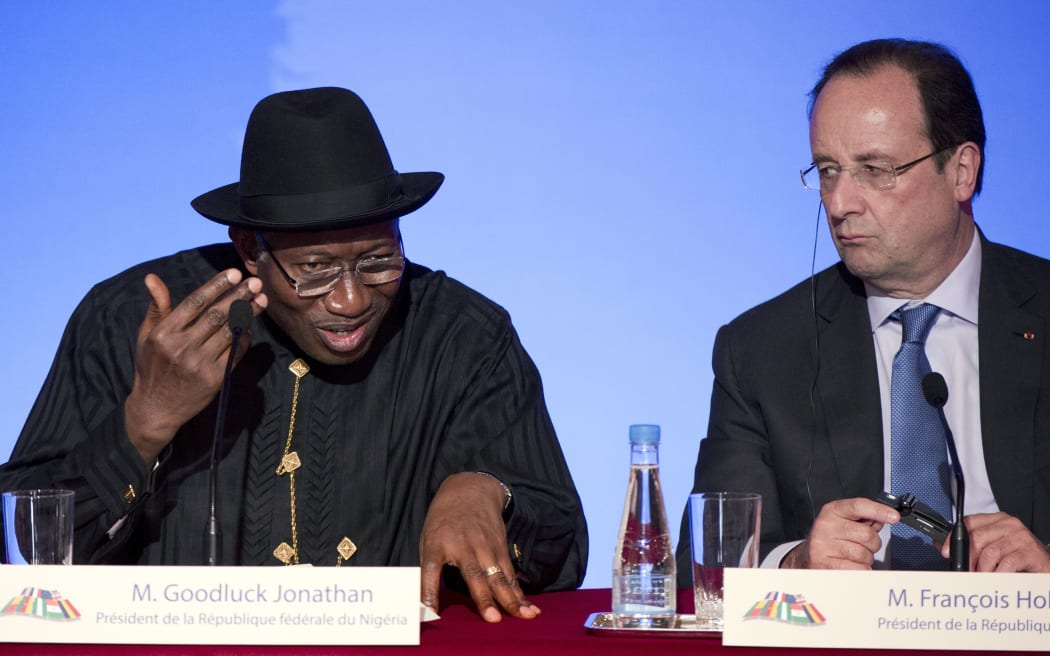 Goodluck Jonathan (left) and Francois Hollande speaking after the summit.