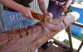 The power pole being carved into a pair of pou was destroyed during Cyclone Gabrielle.