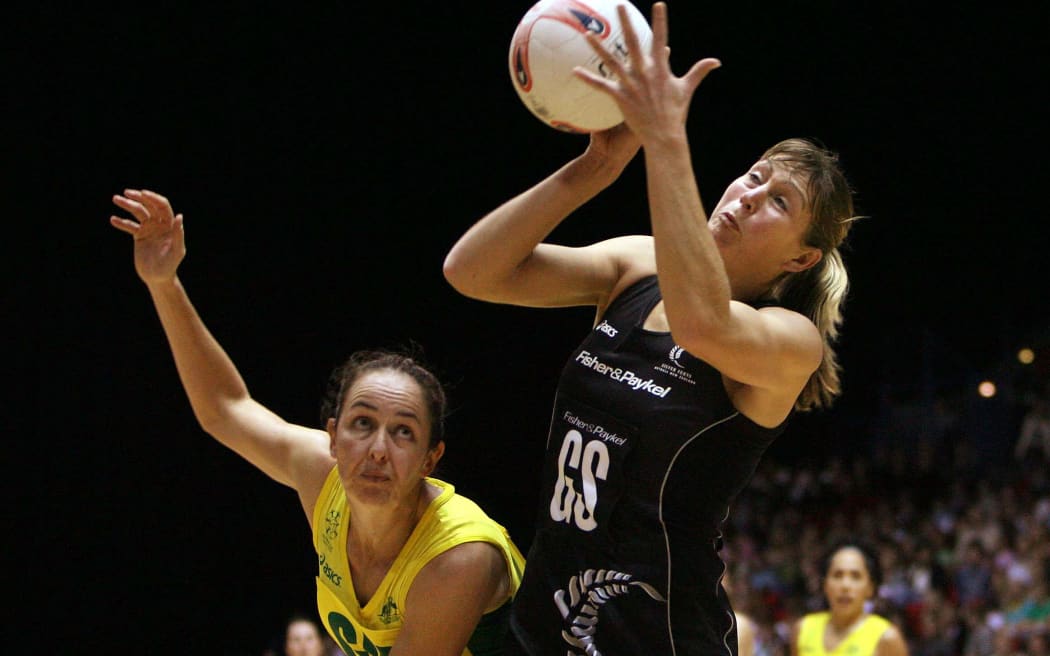 Irene Van Dyk of New Zealand wins the ball ahead of Liz Ellis of Australia