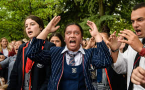 School students perform a haka during a vigil in Christchurch on March 18, 2019.