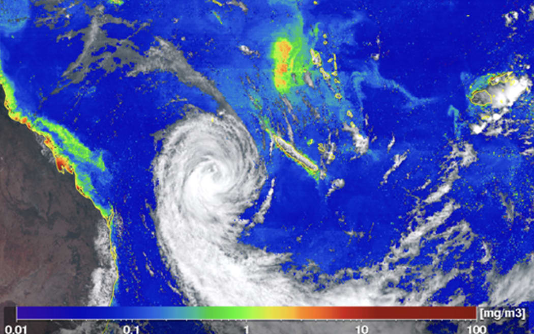 A false colour satellite image of a cyclone off the east coast of Australia, with phytoplankton blooms coloured green and red along the coast and in the Pacific.