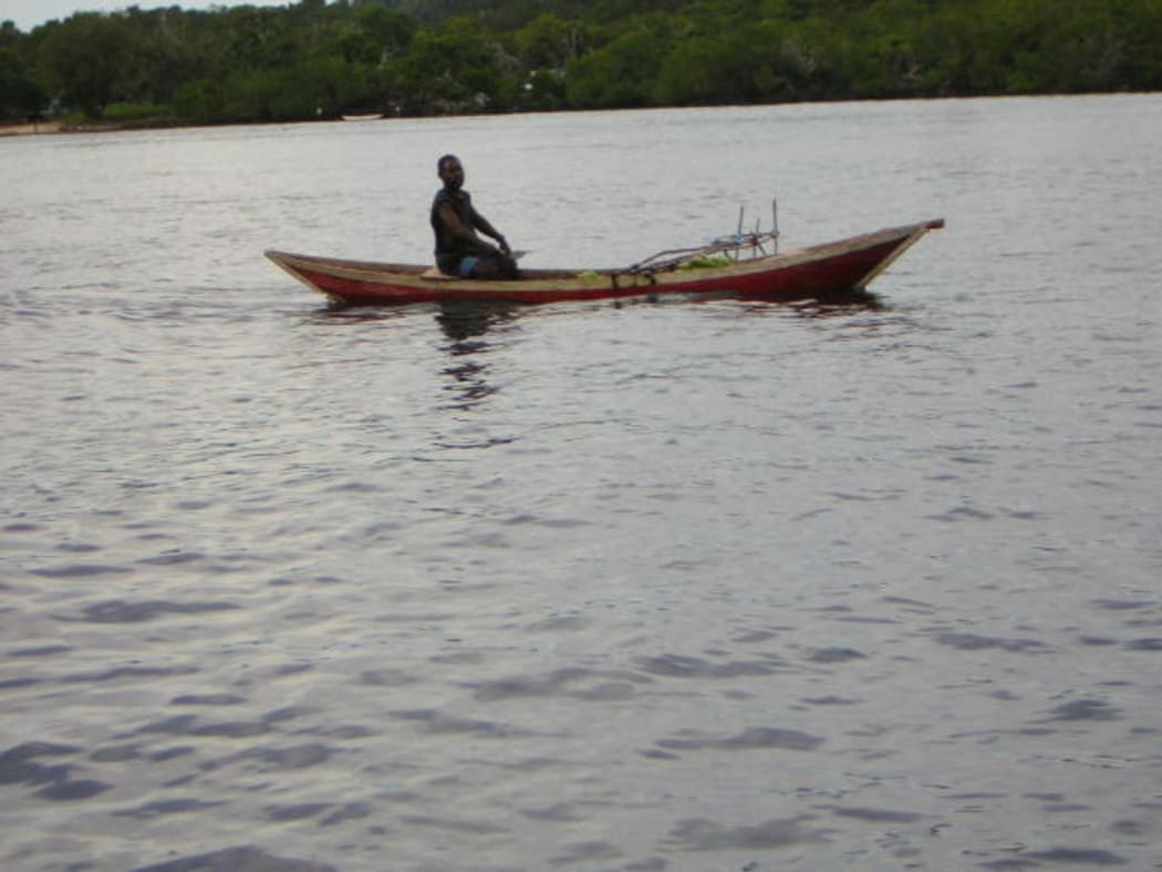 A man in a fishing canoe/boat in Bougainville, Papua New Guinea
