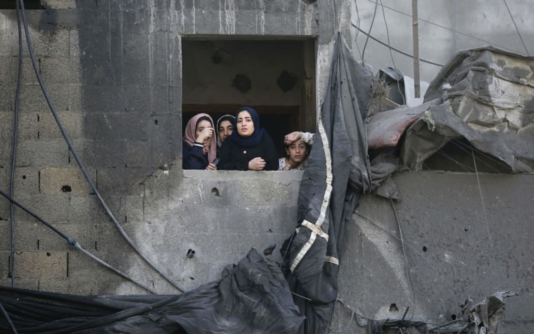 Palestinians gesture as they check the destruction a day after an Israeli strike in the Jabalia camp for Palestinian refugees in the Gaza Strip, on November 1, 2023.