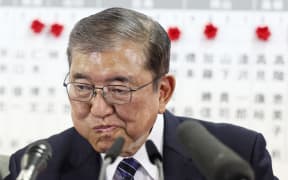 Japan's Prime Minister Shigeru Ishiba reacts during an interview with local media at the Liberal Democratic Party (LDP) headquarters as results in the country's general election are released, in Tokyo on October 27, 2024. - Japan's scandal-hit ruling party fell short of a majority for the first time since 2009 in snap elections on October 27, media projections showed, a blow to new Prime Minister Shigeru Ishiba. (Photo by JIJI PRESS / AFP) / Japan OUT / JAPAN OUT